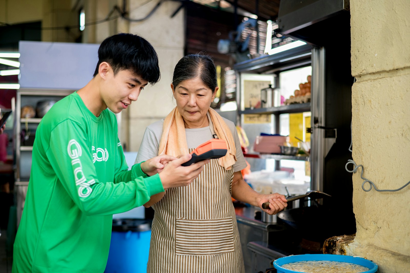 a man and a woman looking at a cell phone